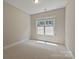 A bright and airy bedroom with a window that lets in natural light, complemented by neutral walls and carpet at 16016 Reynolds Dr, Fort Mill, SC 29707