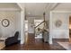 Open entryway featuring hardwood floors, a staircase with wrought iron railings, and stylish décor at 16016 Reynolds Dr, Fort Mill, SC 29707