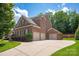 Beautiful brick home with a three-car garage and mature landscaping at 16016 Reynolds Dr, Fort Mill, SC 29707