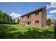 Two-story brick house with a large backyard, patio, and mature trees at 16016 Reynolds Dr, Fort Mill, SC 29707