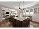 Open concept kitchen with large center island, stainless steel appliances and connection to a living area at 16016 Reynolds Dr, Fort Mill, SC 29707