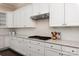 Gourmet kitchen featuring white cabinetry, granite countertops, tiled backsplash and stainless steel appliances at 16016 Reynolds Dr, Fort Mill, SC 29707