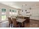 Bright kitchen featuring white cabinets, stainless steel appliances, and a dining table at 16016 Reynolds Dr, Fort Mill, SC 29707