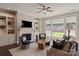 Cozy living room with fireplace, built-in shelving, and hardwood floors for a warm ambiance at 16016 Reynolds Dr, Fort Mill, SC 29707