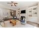 Spacious living room with fireplace, built-in shelving, and hardwood floors at 16016 Reynolds Dr, Fort Mill, SC 29707