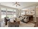 Open-concept living room with natural light, neutral color scheme, and hardwood floors at 16016 Reynolds Dr, Fort Mill, SC 29707