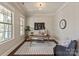 Well-lit home office with ample natural light, neutral colors, and classic design elements at 16016 Reynolds Dr, Fort Mill, SC 29707