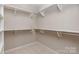 Walk-in closet with carpet flooring, shelving, and racks offering ample storage space at 16016 Reynolds Dr, Fort Mill, SC 29707