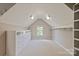Spacious walk-in closet with built-in shelving and storage drawers, lit by recessed lights and a window at 16016 Reynolds Dr, Fort Mill, SC 29707