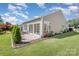 Beautiful backyard with patio area, landscaping, and well-maintained lawn at 16260 Raven Crest Dr, Indian Land, SC 29707