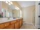 Spacious bathroom features double sinks, ample countertop space, and a glass-enclosed shower, offering a luxurious experience at 16260 Raven Crest Dr, Indian Land, SC 29707