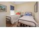 Charming bedroom featuring two twin beds with matching bedding and a window with a blue shade at 16260 Raven Crest Dr, Indian Land, SC 29707