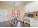Cozy dining area with a desk, built-in storage, and a sunlit view through large windows at 16260 Raven Crest Dr, Indian Land, SC 29707