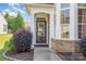 Welcoming front entrance with decorative shrubbery and a well-maintained walkway at 16260 Raven Crest Dr, Indian Land, SC 29707