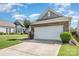 Attached two-car garage with white door, next to a well-kept lawn and landscaped garden at 16260 Raven Crest Dr, Indian Land, SC 29707