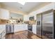 Bright kitchen features white cabinets, stainless steel appliances, and an open view to the living area at 16260 Raven Crest Dr, Indian Land, SC 29707