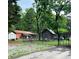Large backyard with multiple structures and ample space for outdoor activities at 169 Smith Clemmer Rd, Mount Holly, NC 28120