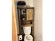 Compact bathroom featuring a wood-accented cabinet above the toilet and practical design at 169 Smith Clemmer Rd, Mount Holly, NC 28120