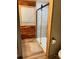 Bathroom with wood-trimmed walls, modern shower, and plank flooring at 169 Smith Clemmer Rd, Mount Holly, NC 28120