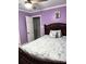 Bedroom with light-purple walls, ceiling fan, and closet access at 169 Smith Clemmer Rd, Mount Holly, NC 28120