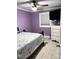 Bedroom features light-purple walls, ceiling fan, and plenty of natural light at 169 Smith Clemmer Rd, Mount Holly, NC 28120