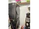 Functional laundry area with stacked washer and dryer, and storage shelves at 169 Smith Clemmer Rd, Mount Holly, NC 28120