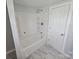 Modern bathroom with a sleek white shower and storage shelves at 1704 16Th Ne St, Hickory, NC 28601