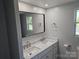 Updated bathroom featuring a double vanity with marble countertop at 1704 16Th Ne St, Hickory, NC 28601