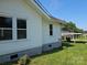 Side exterior view of a home with white siding and visible windows, highlighting the surrounding yard at 1704 16Th Ne St, Hickory, NC 28601