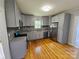 Renovated kitchen with gray cabinets, granite counters, stainless appliances, and hardwood floors at 1704 16Th Ne St, Hickory, NC 28601