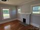 Living room with hardwood floors, fireplace, and bright windows at 1704 16Th Ne St, Hickory, NC 28601