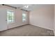 Bright bedroom featuring neutral walls, carpet, ceiling fan, and double windows at 2117 Copperplate Rd, Charlotte, NC 28262