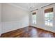 Elegant dining room with decorative wall trim, hardwood floors, and ample light from two windows at 2117 Copperplate Rd, Charlotte, NC 28262