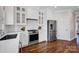 Updated kitchen with white cabinets, stainless steel appliances, and hardwood floors at 2117 Copperplate Rd, Charlotte, NC 28262