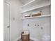 Functional laundry room with ample shelving and a woven storage basket at 2117 Copperplate Rd, Charlotte, NC 28262