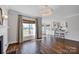 Bright living room featuring hardwood floors, a modern chandelier, and an open layout to the kitchen at 2117 Copperplate Rd, Charlotte, NC 28262
