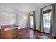 Elegant living room with hardwood floors, large windows, and decorative crown molding at 2117 Copperplate Rd, Charlotte, NC 28262
