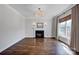 Comfortable living room with fireplace, hardwood floors, and a large window for natural light at 2117 Copperplate Rd, Charlotte, NC 28262