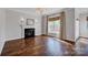Inviting living room featuring a cozy fireplace, hardwood floors, and a sun-filled window at 2117 Copperplate Rd, Charlotte, NC 28262