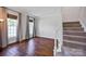 Cozy living room featuring hardwood floors, large windows, and a staircase at 2117 Copperplate Rd, Charlotte, NC 28262