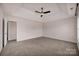 Expansive main bedroom with tray ceilings, carpet, fan, and lots of natural light at 2117 Copperplate Rd, Charlotte, NC 28262