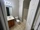 This is a bathroom featuring a shower over the tub, a mirror and vanity at 2150 Winthrop Chase Dr, Charlotte, NC 28212