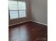 Bright bedroom with hardwood floors and a large window offering lots of natural light at 2150 Winthrop Chase Dr, Charlotte, NC 28212