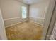 A cozy bedroom with neutral walls, carpeted flooring, and a window offering natural light at 2150 Winthrop Chase Dr, Charlotte, NC 28212