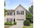 Charming two-story home featuring a front-entry garage, well-maintained landscaping, and classic architectural details at 2150 Winthrop Chase Dr, Charlotte, NC 28212