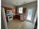 Efficient kitchen design with essential appliances and access to an outdoor area at 2150 Winthrop Chase Dr, Charlotte, NC 28212