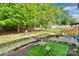 Large, lush backyard featuring mature trees and an outdoor dining area on artificial turf at 2926 Royal Fern Ln, Charlotte, NC 28215