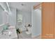 A modern bathroom featuring a bathtub and a separate vanity with double sinks at 2926 Royal Fern Ln, Charlotte, NC 28215