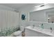 Bright bathroom featuring a shower with leafy-green curtain, and neutral vanity with sink at 2926 Royal Fern Ln, Charlotte, NC 28215