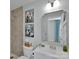 Bathroom featuring a tiled shower, decor, and neutral vanity with sink and chrome hardware at 2926 Royal Fern Ln, Charlotte, NC 28215